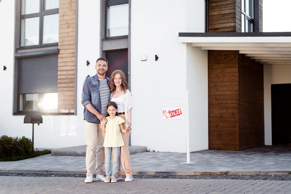Real estate agent hosting a well-organized open house with digital check-in tools